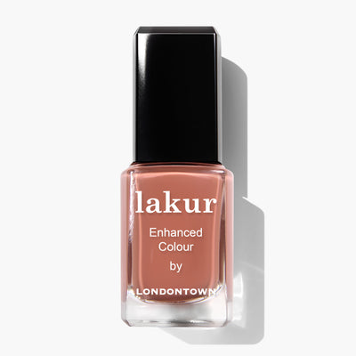 A bottle of Lakur Enhanced Colour nail polish by LONDONTOWN, named Pecan Pie, featuring a brownish-pink, milk chocolate shade and a black cap. This PETA certified, vegan, cruelty-free product adds a touch of elegance to any look.