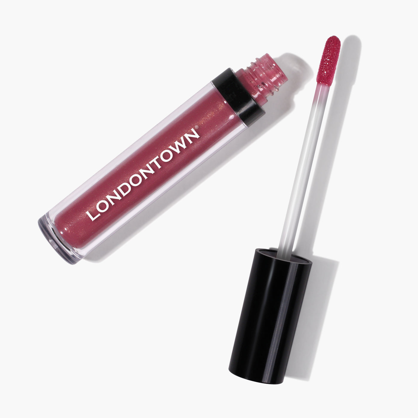 A tube of LONDONTOWN's Plush Shine Lip Gloss in the shade 'Posh' with its applicator wand partially removed, revealing the flushed pink gloss.