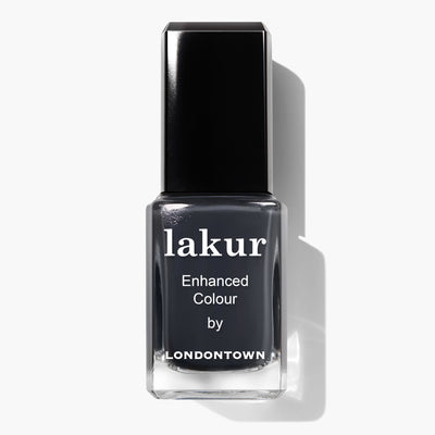 A bottle of Lakur Enhanced Colour nail polish in the shade "Put the Kettle On" by LONDONTOWN, featuring a dark gray hue and a black cap. This vegan, cruelty-free nail polish is also 16+ Free, making it an excellent choice for conscious consumers.