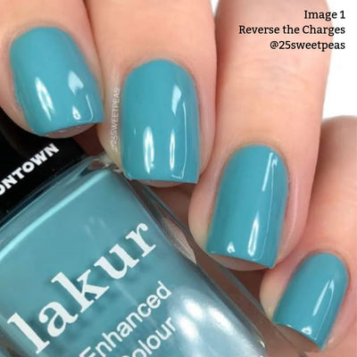 Close-up of fingernails painted with glossy turquoise nail polish from a bottle labeled "Reverse the Charges (Professional)" by LONDONTOWN; this vegan, cruelty-free formula showcases an aqua and turquoise brilliance.