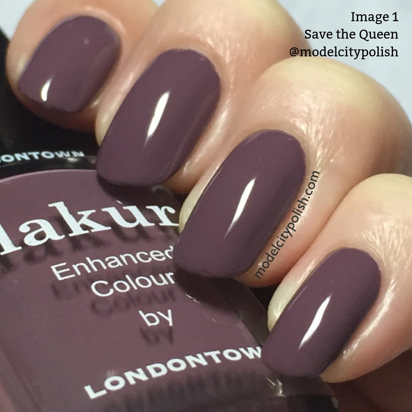 Close-up of fingers with glossy, mauve nail polish labeled "Save the Queen (Professional)" by LONDONTOWN. Enhanced with Florium Complex, the vegan and cruelty-free formula ensures long-lasting wear. The black cap features the brand's logo.