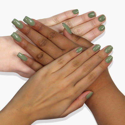 Four hands with different skin tones showcase matching succulent jade green nail polish, Sedona by LONDONTOWN, on a white background, enhanced by an accelerating drying oil. The vegan, cruelty-free formula ensures a guilt-free and vibrant manicure for everyone.