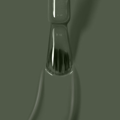 Close-up of a Star Moss vegan cruelty-free green glass laboratory pipette by LONDONTOWN, filled with liquid and casting a shadow against a similarly colored background.