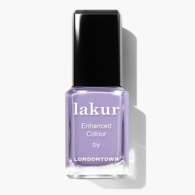 A bottle of Trolley Away by LONDONTOWN, featuring a lilac crème shade and a black cap, is vegan and cruelty-free.