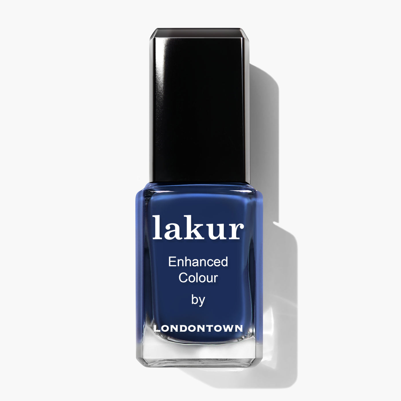 A bottle of LONDONTOWN Under the Stars lakur nail polish in a vintage denim deep blue color, labeled "Enhanced Colour.