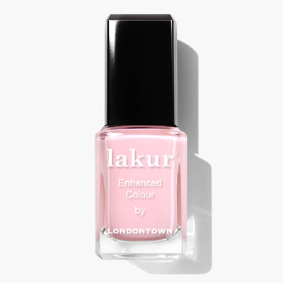 A bottle of LONDONTOWN lakur Enhanced Colour nail polish in Waterloo Sunset with a black cap. This vegan nail polish exudes elegance and is perfect for any occasion.