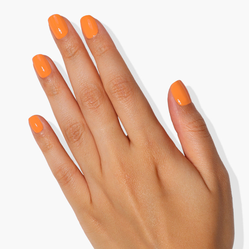 A hand with polished nails painted in LONDONTOWN's Heat Wave color is shown against a white background.