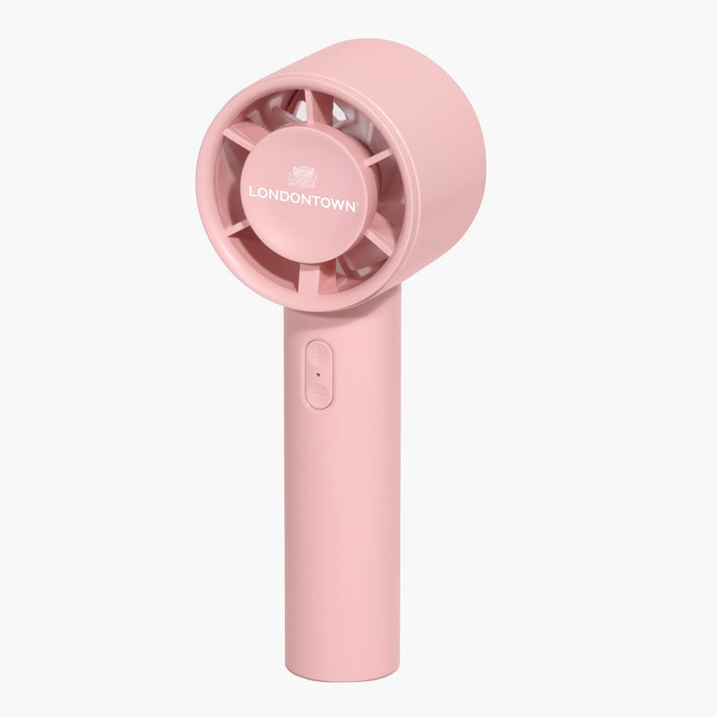 The LONDONTOWN Cool Set Nail Fan - Petal is a handheld, battery-operated pink fan with "LONDONTOWN" branding on the front, featuring a circular vent and an on/off switch on the handle—this convenient device doubles as a portable dryer to help achieve shorter dry times wherever you go.
