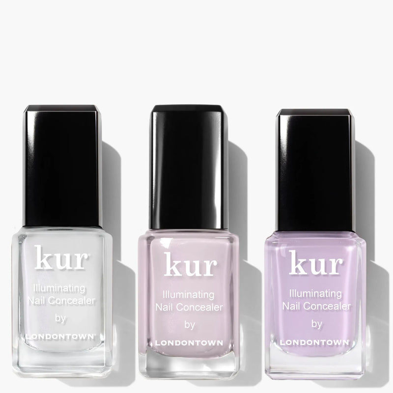 Three bottles from LONDONTOWN's Illuminating Nail Concealer Trio are arranged side by side in clear, light pink, and light purple shades.