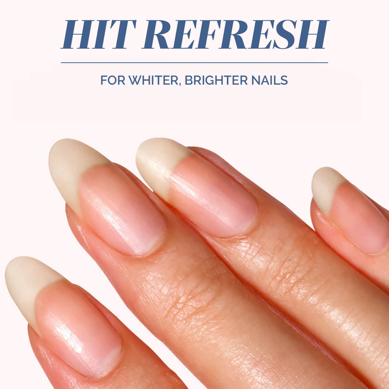A close-up of a hand with long, healthy nails holds Mani Bright Nail Scrub by LONDONTOWN against a light background, featuring the text "Hit Refresh: Nail Treatment for Whiter, Brighter Nails." Ideal for reviving stained nails.