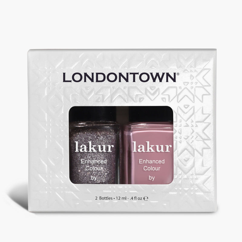 The LONDONTOWN Midnight Frost Duo features two nail polishes—one shimmery dark shade and one mauve pink—packaged in a white patterned box with a clear window.