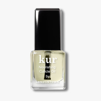 A glass bottle of LONDONTOWN Mini Nourishing Cuticle Oil with a black cap, clear oil, and white text on the front label.