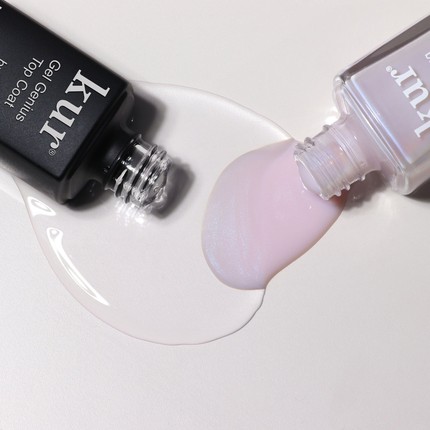 An opened LONDONTOWN Conceal & Go - Pink: Holiday Edition nail polish lies next to a black bottle, their spilled colors mingling on the surface—evoking flawless nails and mindful nail care.