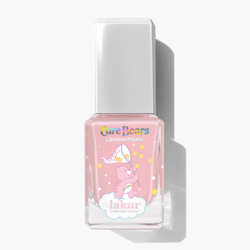 A square glass bottle of BFF pink nail polish by LONDONTOWN, with a white cap, features Care Bears branding and an illustration of a bear in a wizard hat surrounded by stars.