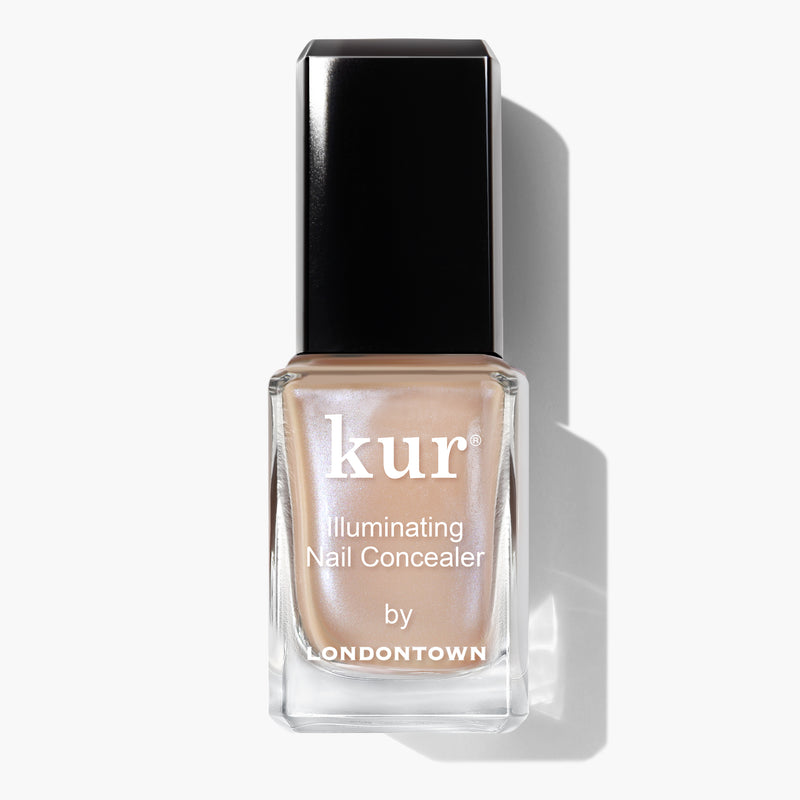 A bottle of Bare Illuminating Nail Concealer by LONDONTOWN is shown. The bottle has a black cap and clear glass that reveals a lustrous beige nail polish inside.