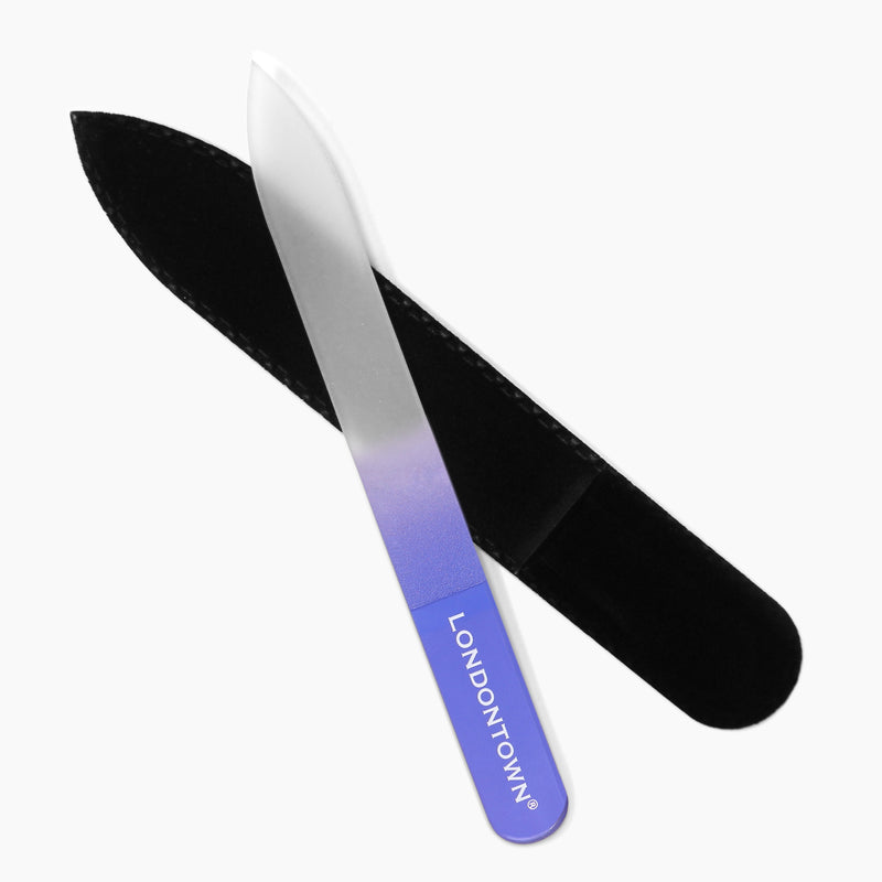 A glass nail file named "Glass Nail File - Lilac" from LONDONTOWN, featuring a purple and clear gradient handle for effortless nail filing, includes a black protective case.