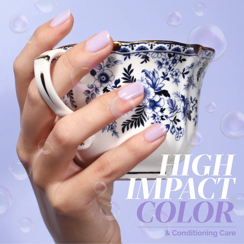 A hand with neatly manicured, pastel pink nails shows off LONDONTOWN’s Cloud Nine against a dreamy periwinkle backdrop, holding a floral teacup, with the text: "HIGH IMPACT COLOR & Conditioning Care.