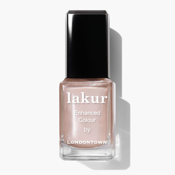 A bottle of LONDONTOWN Cold Foam Lakur Enhanced Colour nail polish in a pale pink whipped pearl shade with a sleek black cap.