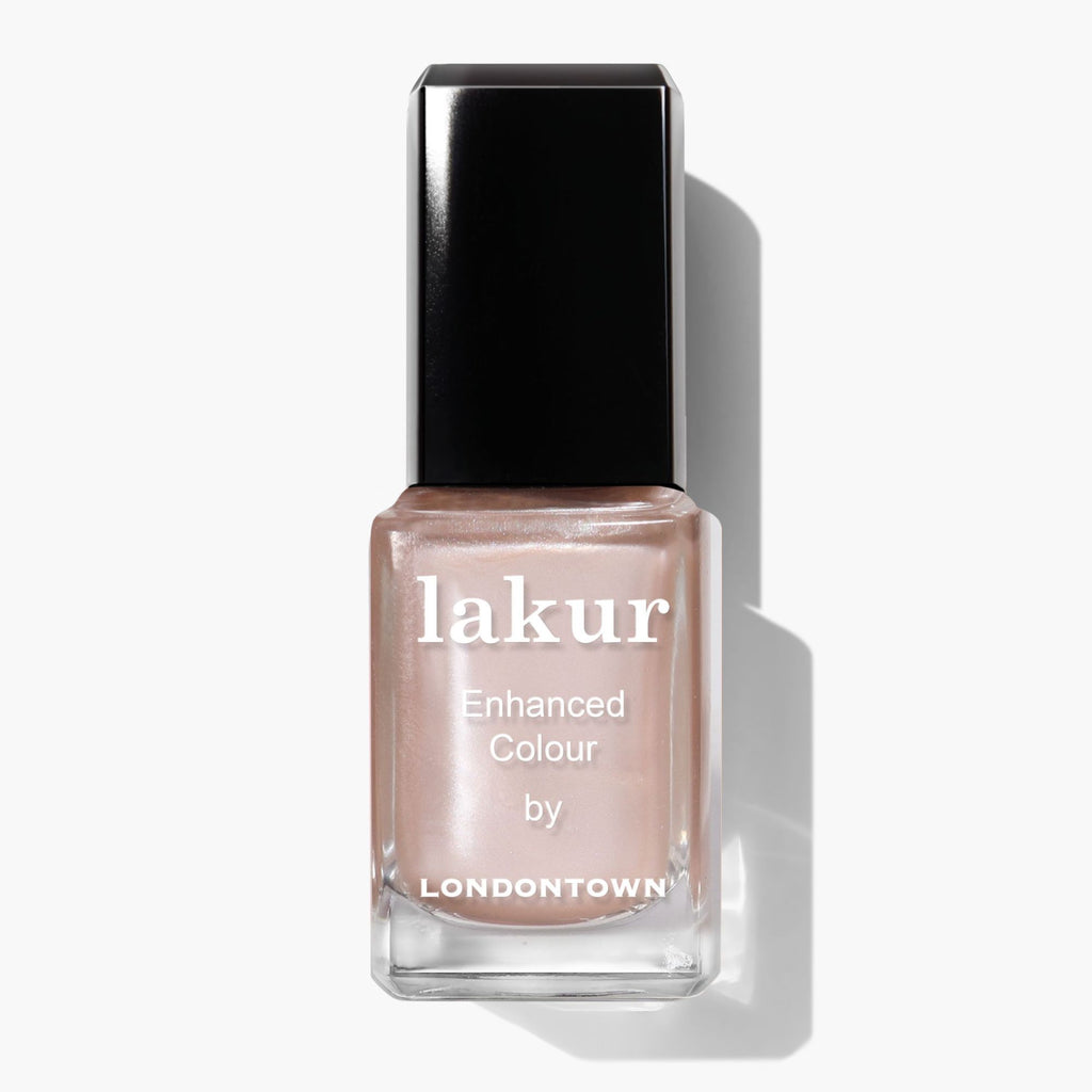 A bottle of LONDONTOWN Cold Foam Lakur Enhanced Colour nail polish in a pale pink whipped pearl shade with a sleek black cap.