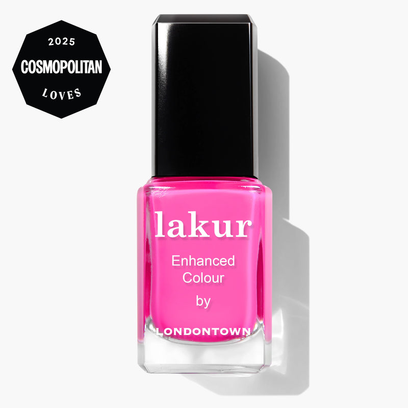 A bottle of LONDONTOWN Lakur Enhanced Colour nail polish in Berry Punch (pink) with a 2025 Cosmopolitan Loves badge in the top left corner.