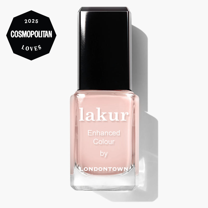 A bottle of LONDONTOWN lakur Cheerio vegan nail polish in a sheer neutral pink, featuring the "2025 Cosmopolitan Loves" badge in the top left corner. Ideal for achieving a fresh French manicure look.
