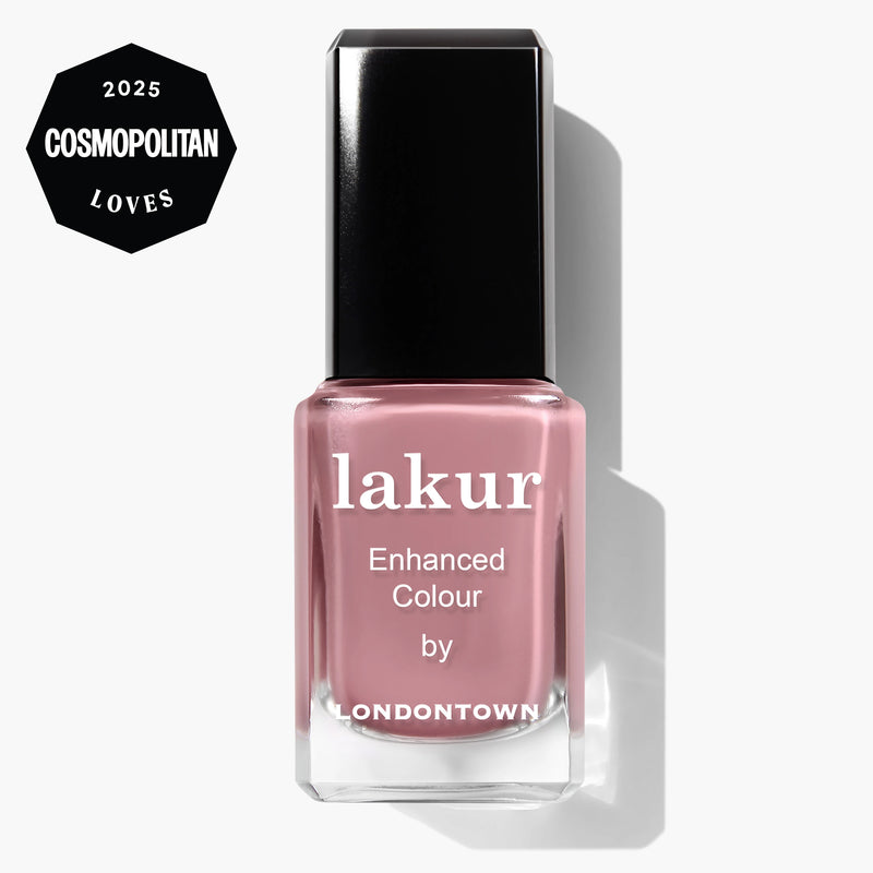 A bottle of LONDONTOWN lakur vegan nail polish in the shade "Crowning Crumpet," a muted pink, with a "2025 Cosmopolitan Loves" badge in the top left corner.