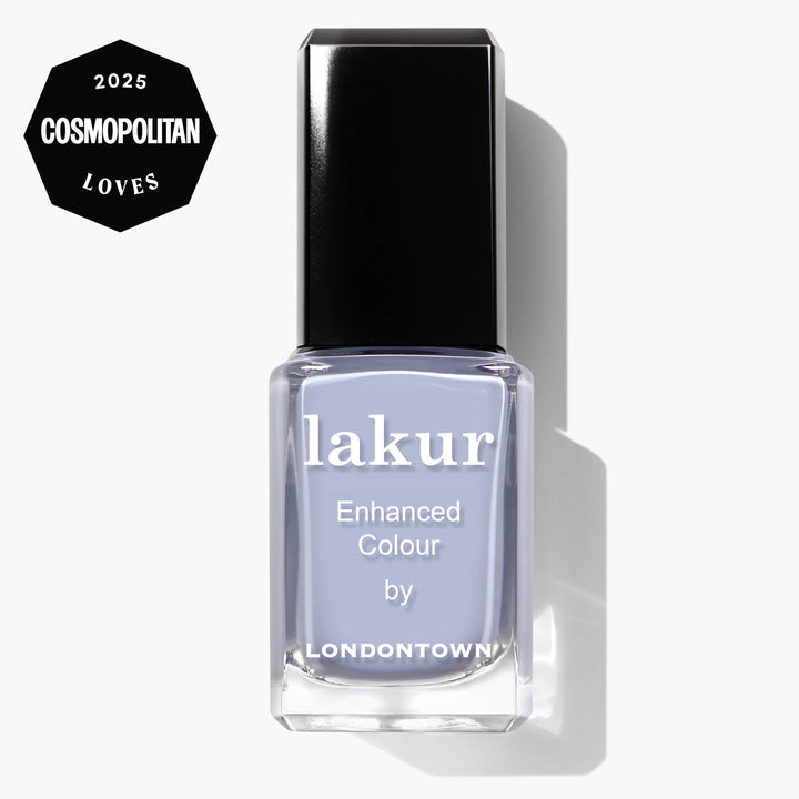 A bottle of LONDONTOWN Dainty Daze vegan nail polish in light purple, featuring a "2025 Cosmopolitan Loves" badge in the corner.