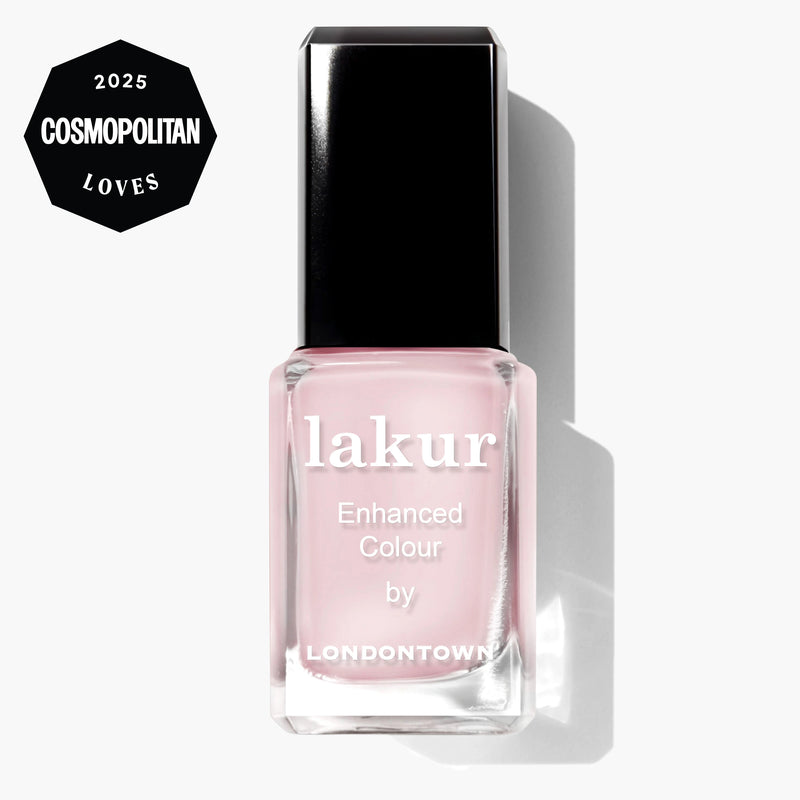 A bottle of LONDONTOWN Macaroon at Noon Lakur in pastel powder pink, exuding delicate charm, with a "2025 Cosmopolitan Loves" badge in the top left corner.