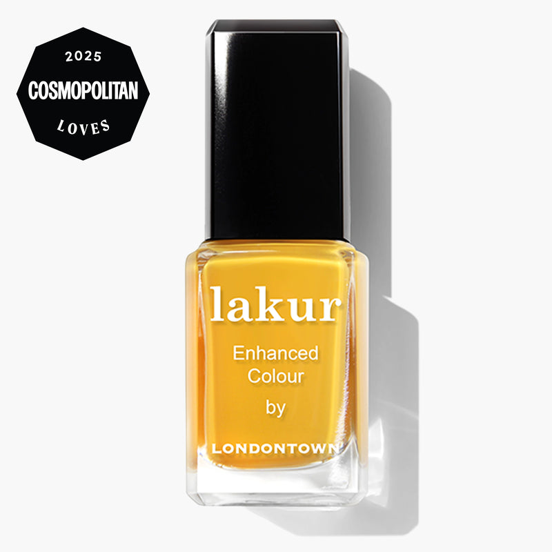 A bottle of LONDONTOWN Mango lakur nail polish labeled "Enhanced Colour," featuring a "2025 Cosmopolitan Loves" badge. This vegan, cruelty-free polish provides vibrant color with a glossy finish.