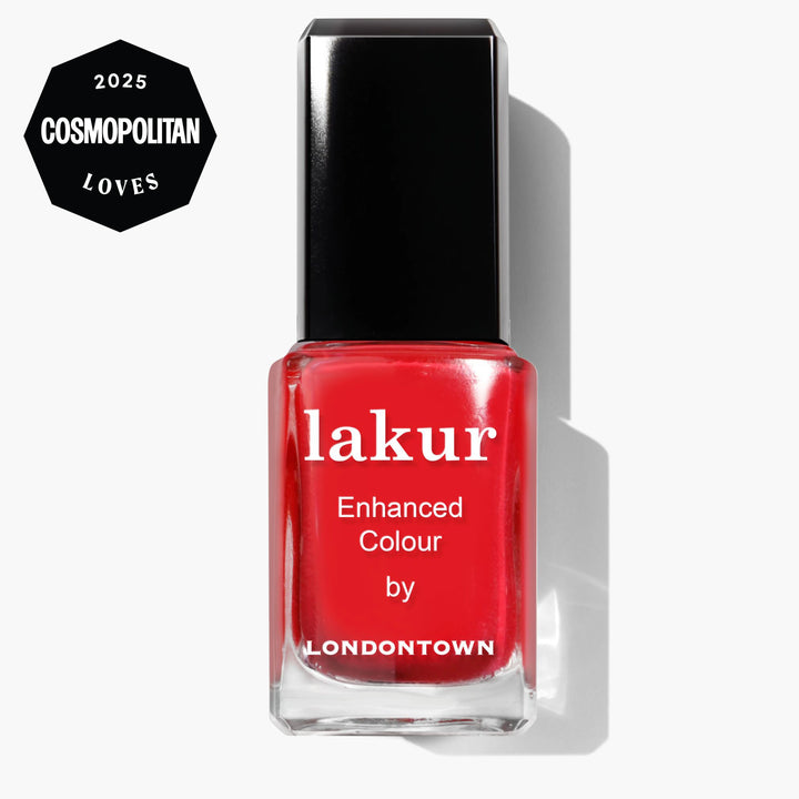 A bottle of LONDONTOWN Lakur Enhanced Colour in Maraschino Cherry, a bright red nail polish with a black cap, featuring a "2025 Cosmopolitan Loves" badge in the top left corner.