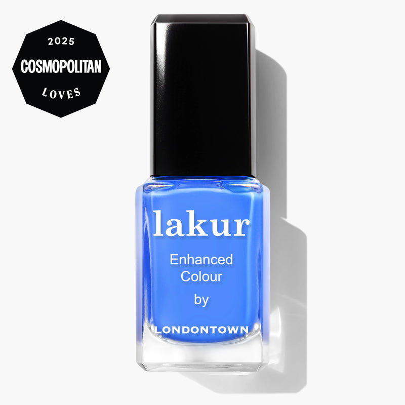A bottle of LONDONTOWN Poolside Dreams vegan blue nail polish with a “2025 Cosmopolitan Loves” badge in the top left corner.