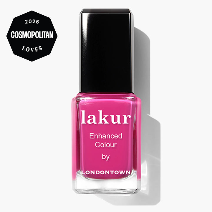 A bottle of LONDONTOWN Summer Fling Lakur Enhanced Colour nail polish in shocking pink, featuring a "2025 Cosmopolitan Loves" badge. This cruelty-free polish delivers bold color with a conscience.