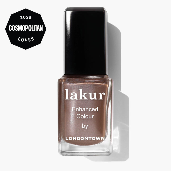 A bottle of LONDONTOWN Lakur Enhanced Colour nail polish in the shade Affogato, a shimmering metallic brown, is shown against a white background with a Cosmopolitan Loves 2025 badge in the top left corner.