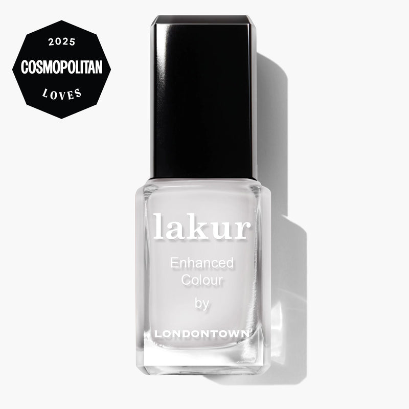 A bottle of LONDONTOWN Double Scoop Lakur nail polish in creamy white, with a "2025 Cosmopolitan Loves" badge in the top left corner, shown on a white background.