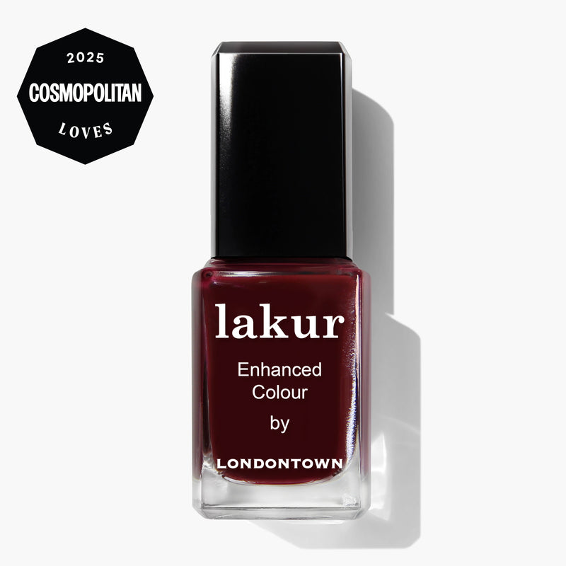 A bottle of LONDONTOWN Lakur Enhanced Colour nail polish in the shade "Elderberry," a deep red, is featured with a "Cosmopolitan Loves 2025" badge in the top left corner.