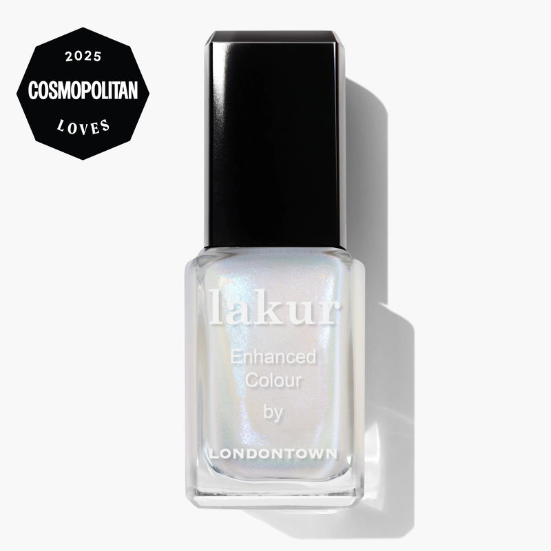 A bottle of LONDONTOWN Milk Bath Lakur Enhanced Colour nail polish with soap bubble iridescence and a pearlescent finish is displayed against a white background, featuring a "2025 Cosmopolitan Loves" badge in the top left corner.