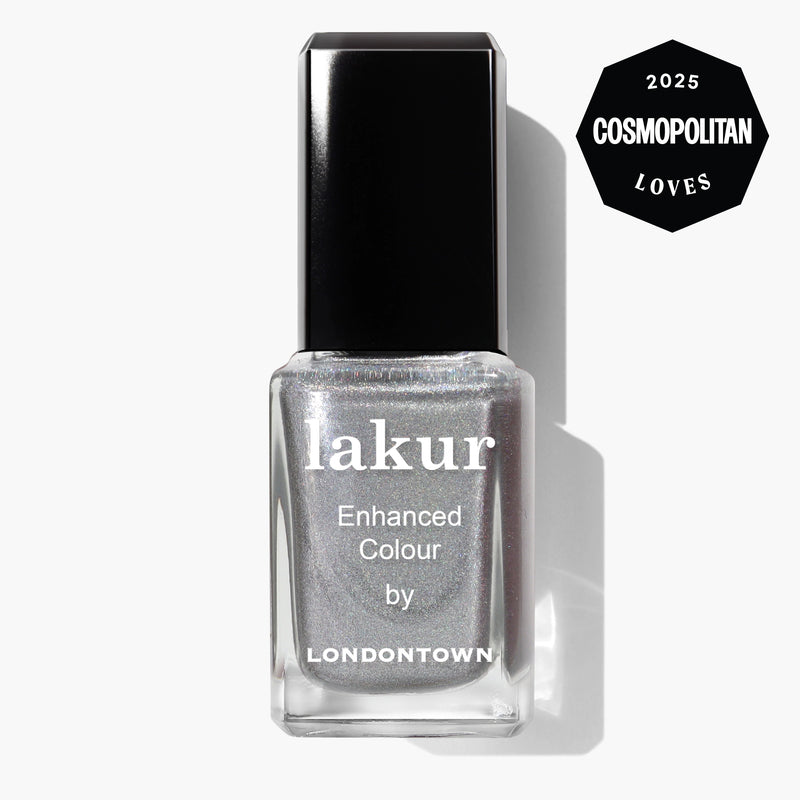 A bottle of LONDONTOWN Lakur Enhanced Colour nail polish in the "Nice & Icy" platinum, shimmery silver shade, featuring a "2025 Cosmopolitan Loves" badge in the top right corner.