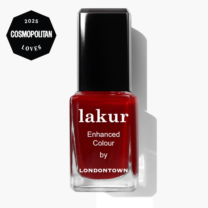 A bottle of LONDONTOWN lakur in Truly Ruby red with a black cap, labeled "Enhanced Colour," is placed next to a badge reading "2025 Cosmopolitan Loves.