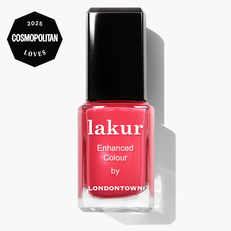 A bottle of LONDONTOWN Weekend Cheers coral pink vegan nail polish with a black cap, featuring a "2025 Cosmopolitan Loves" badge in the top left corner.