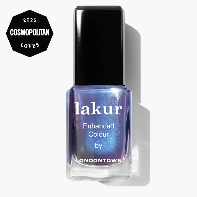 A bottle of LONDONTOWN lakur nail polish in the "Wildberry Freeze" blue shimmer shade, featuring a 2025 Cosmopolitan Loves badge in the corner.