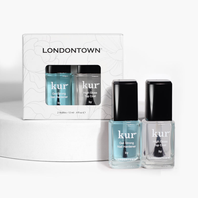 A set of two bottles from LONDONTOWN, the Strength & Shine Duo, includes "Gel Strong Nail Hardener" for the strongest nails and "High Gloss Top Coat" for the shiniest nails. The products are displayed on a white surface with their packaging in the background.