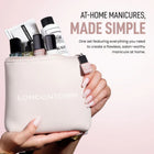 A hand with manicured nails holds a LONDONTOWN pouch filled with polishes and manicure essentials. Text highlights the Londontown Discovery Set 2.0—a complete introductory kit for the perfect at-home manicure.