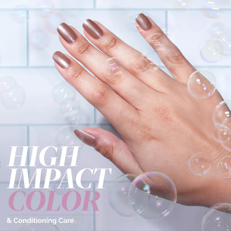 A hand with shimmering mauve metallic rose gold LONDONTOWN "Extra Bubbles, Please" nail polish is shown against a tiled background with floating bubbles. Text reads: “High Impact Color & Conditioning Care.”.