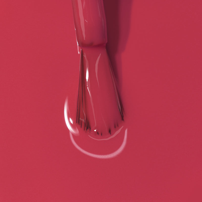 Close-up image of a brush applying LONDONTOWN's Flushed Cheeks nail polish.