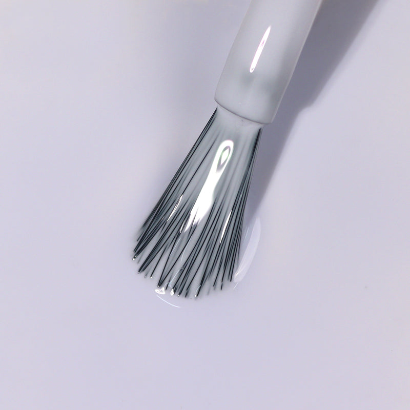 Close-up of LONDONTOWN's Frostbitten nail polish brush with bristles immersed in the icy white polish.