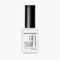 A white bottle of LONDONTOWN GelShift Top Coat with a black cap is shown against a plain background, ideal for sealing your gel manicure or adding shine to your favorite polish.