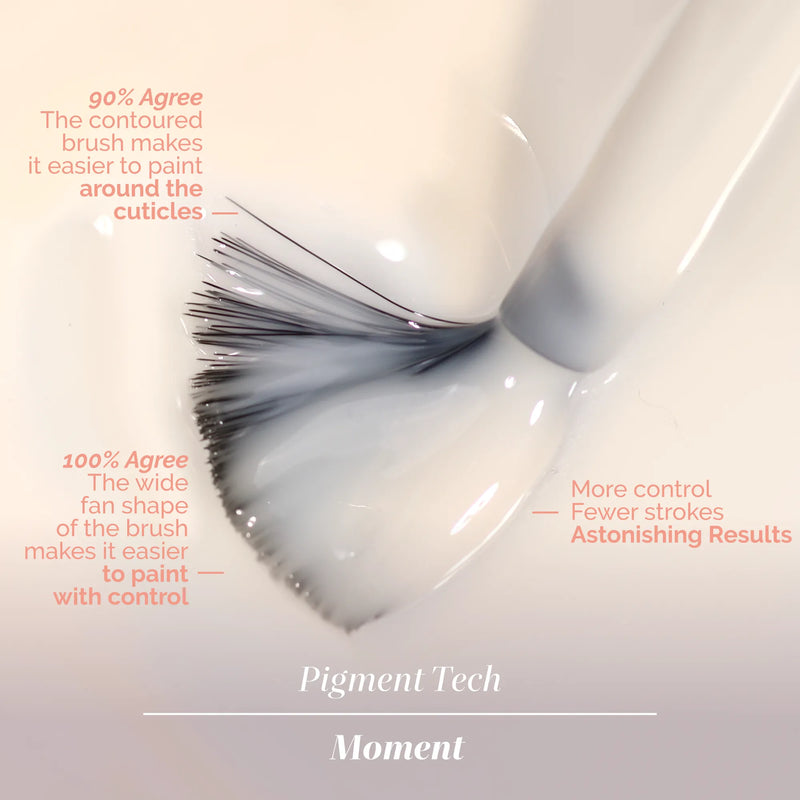 Close-up of LONDONTOWN's Good Vibes Only contoured fan-shaped brush dipped in white liquid, highlighting easy painting around cuticles and precise control—set against a warm, sunlit peach background.