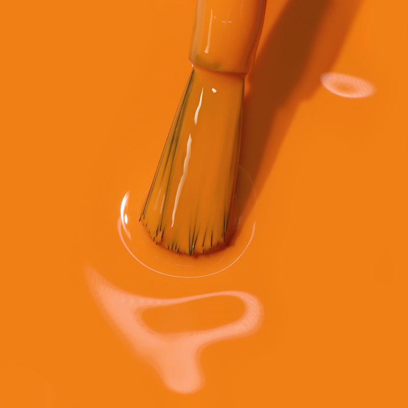 Close-up image of a LONDONTOWN Heat Wave paintbrush dipped in bright burnt orange paint, creating smooth, reflective surface ripples.