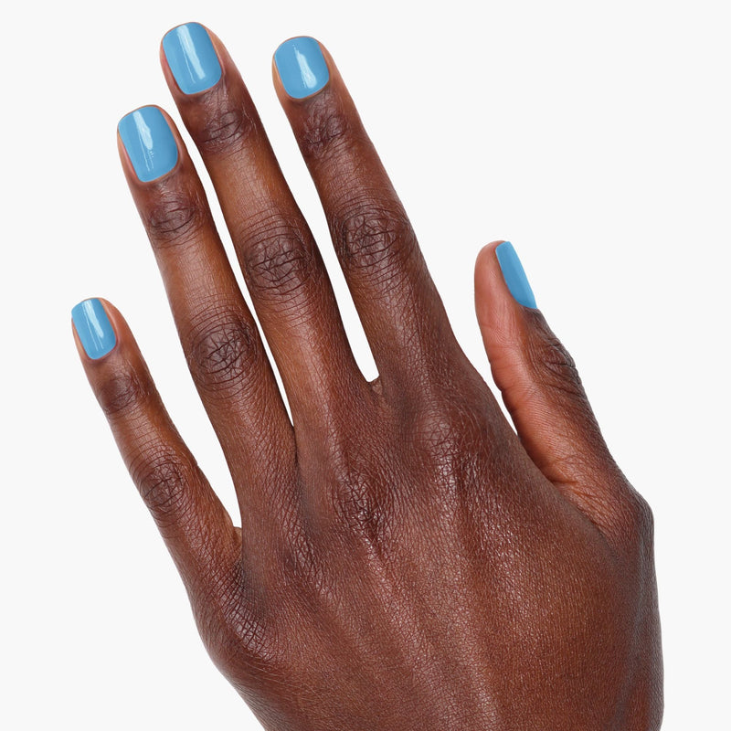 A hand adorned with LONDONTOWN's Hot Spring nail polish on all five fingernails is displayed against a plain white background.