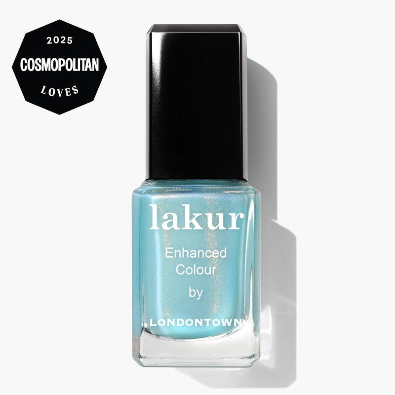 A bottle of LONDONTOWN’s Lakur nail polish in Aegean Aqua, a seawater-inspired light blue, featuring a "2025 Cosmopolitan Loves" badge in the top left corner.